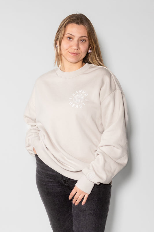 Female model looking forward and wearing a bone crewneck with white lettering.