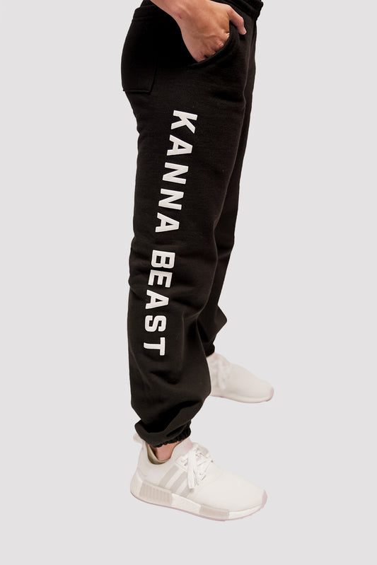 Model wearing the black Kanna Beast Sweatpants showing the right side featuring white puff print words reading Kanna Beast.