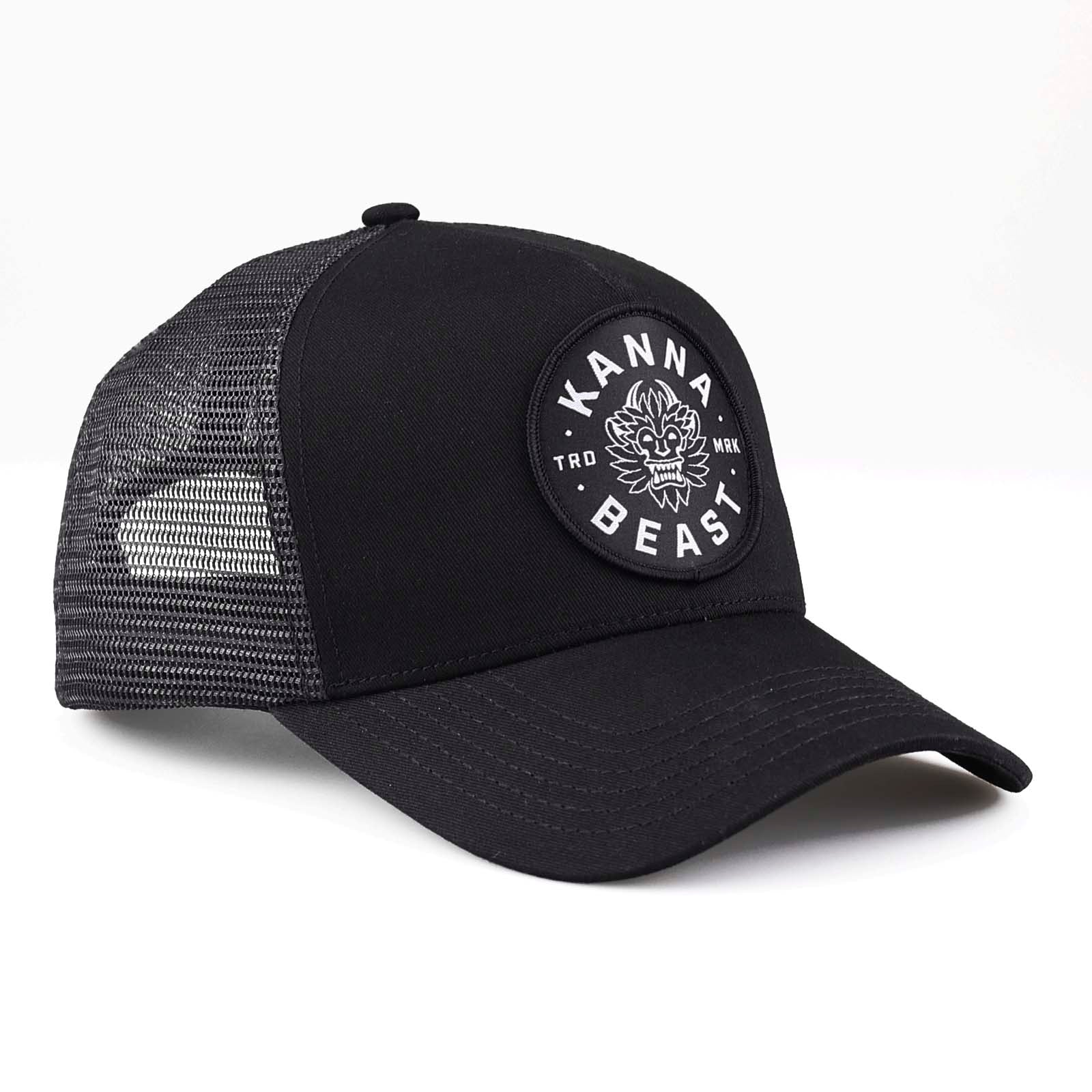 Kanna Beast Trucker Hat in all black against a white background. 