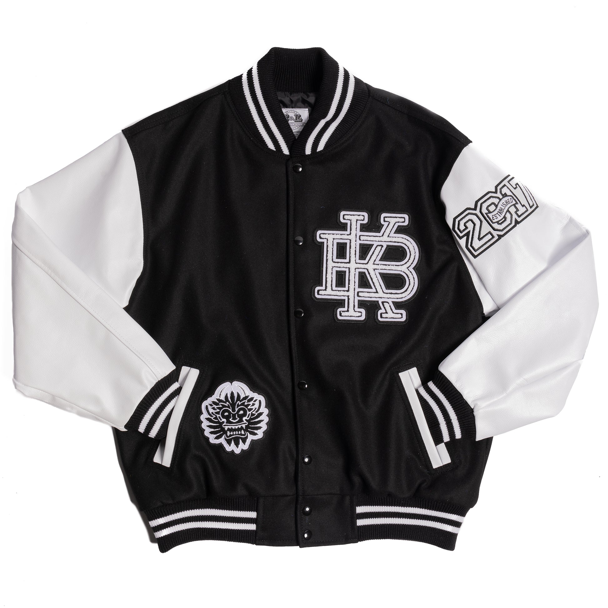 Flat lay image of Kanna Beast Letterman Jacket. With white leather sleeves, black wool body and three chenille patches of our logo, KB, and 2017 established year. 